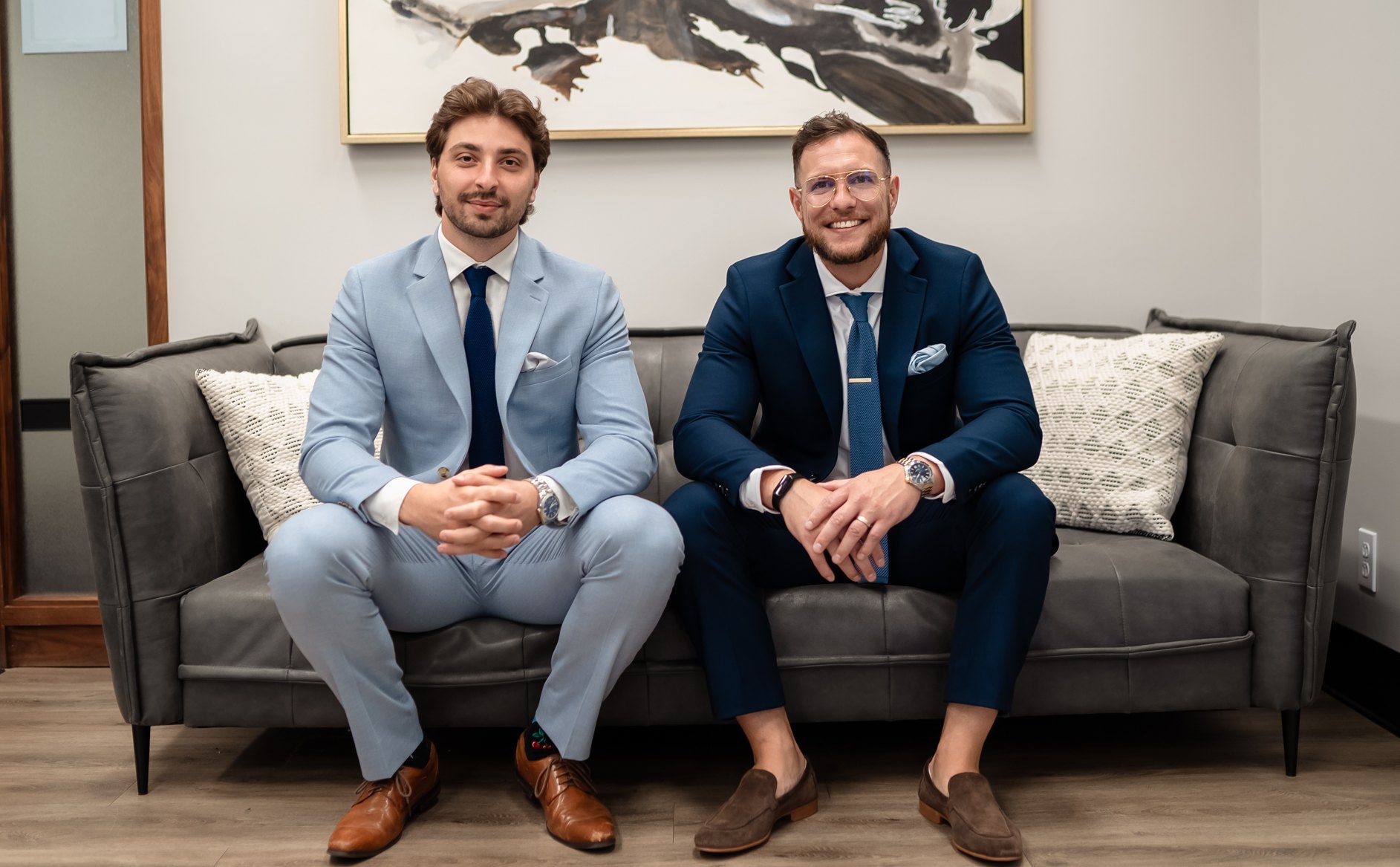 William and Joey, co-founders of Clean Club, sitting side by side in suits